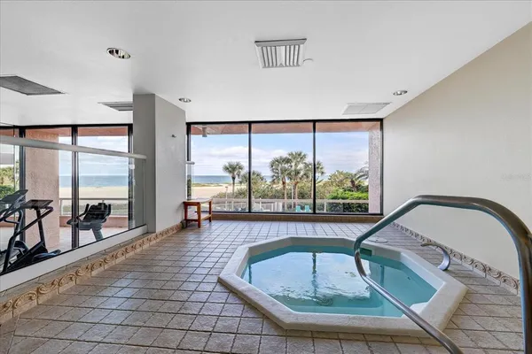 a room with pool table and windows