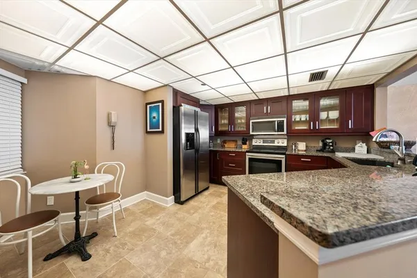 a kitchen with stainless steel appliances granite countertop a sink stove and refrigerator