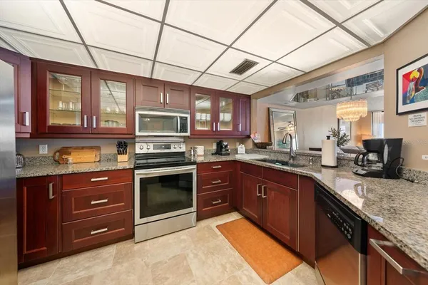a kitchen with stainless steel appliances granite countertop a stove cabinets and a sink