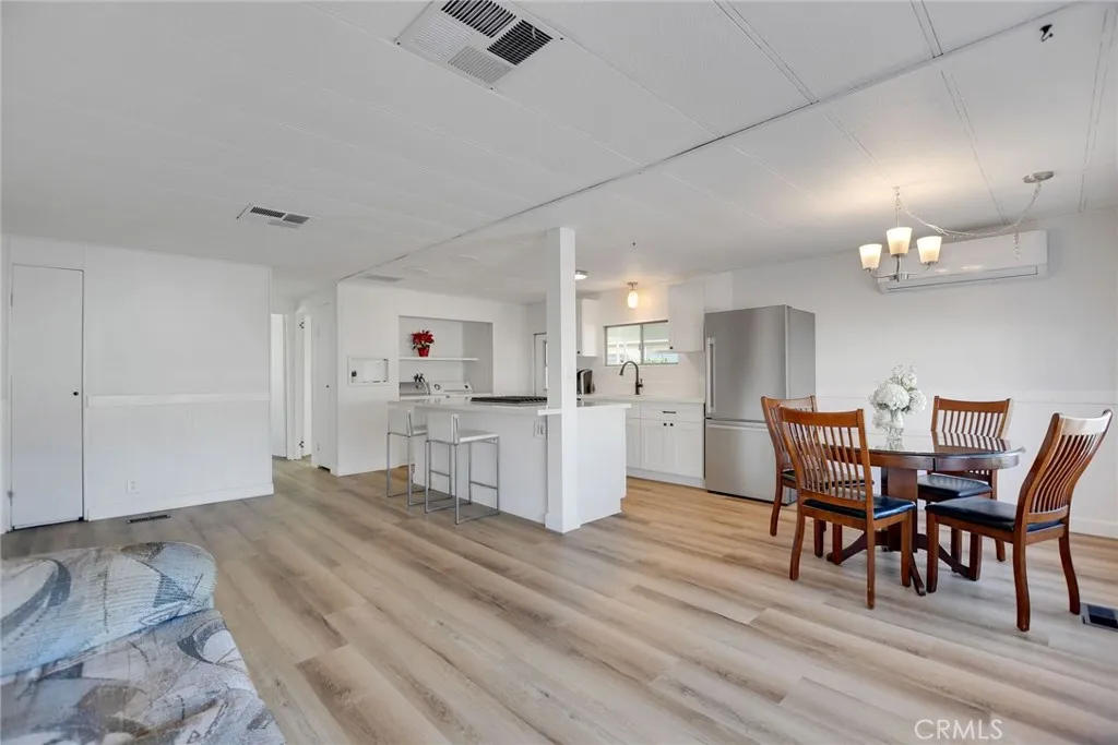 840 Foothill, Unit 27 Azusa, CA 91702 - Photo 7 of 30 a view of a dining room with furniture and wooden floor