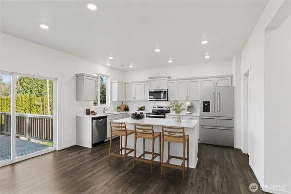 a kitchen with white cabinets and stainless steel appliances