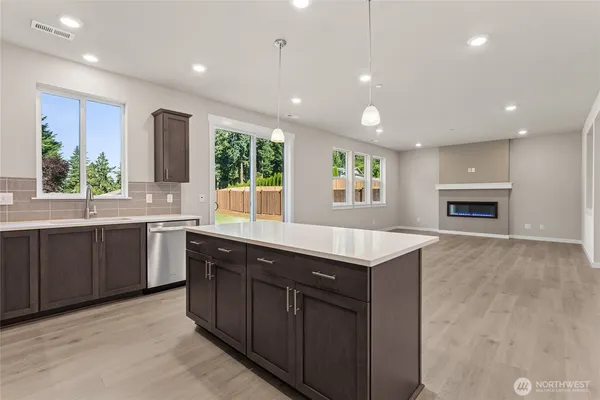 a kitchen with a sink window and cabinets