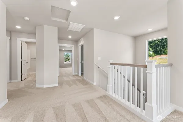 a view of a hallway with wooden floor and entryway
