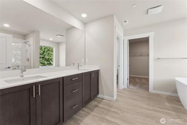 a bathroom with a double vanity sink and mirror
