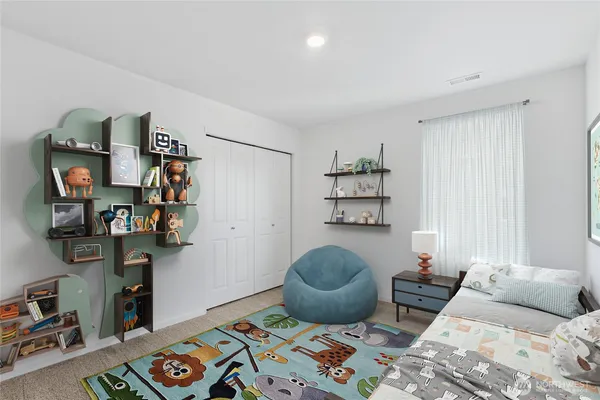 a bedroom with furniture and a book shelf