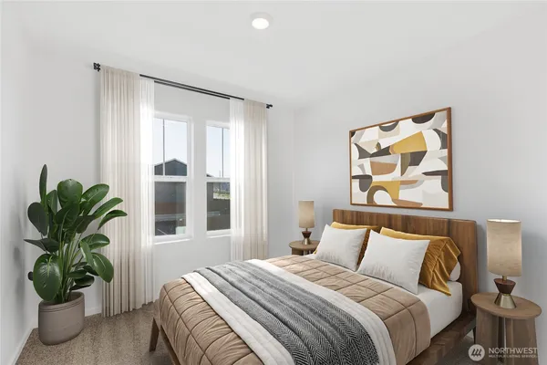 a bedroom with a bed and a potted plant