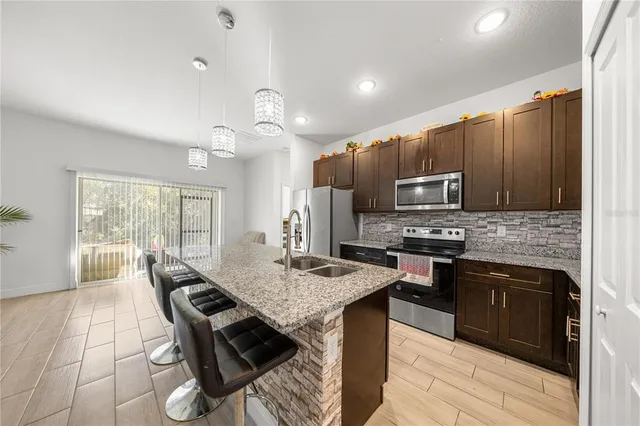 a bathroom with a granite countertop sink a toilet and a shower