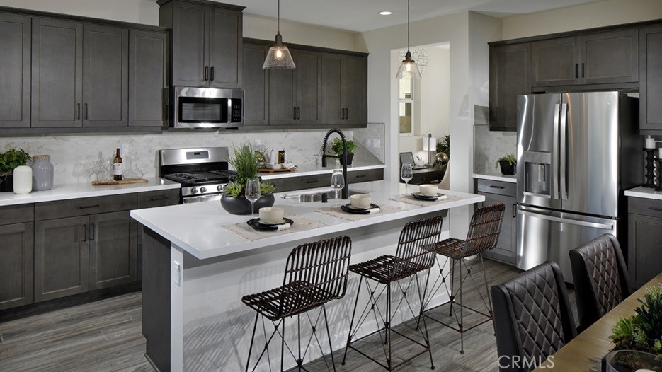 36970 Corvina Way Beaumont, CA 92223 - Photo 3 of 12 a kitchen with a sink stainless steel appliances and cabinets
