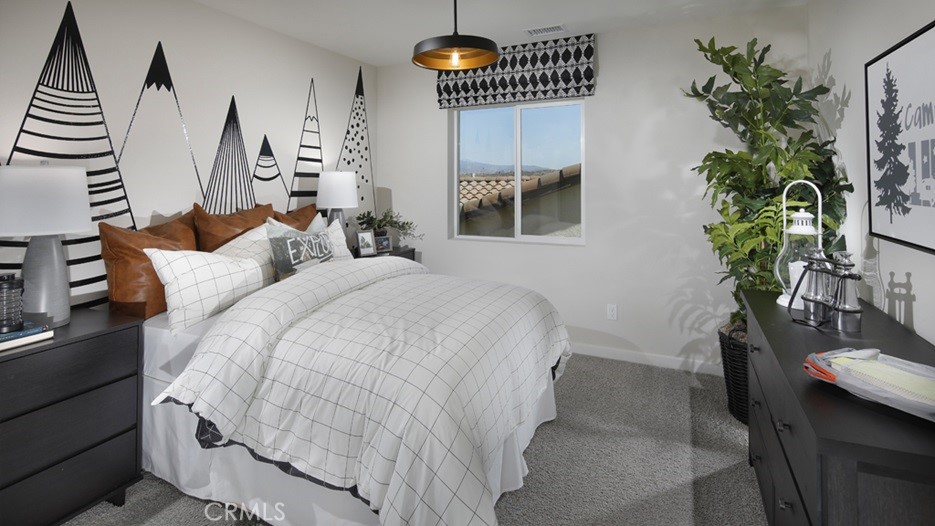 36970 Corvina Way Beaumont, CA 92223 - Photo 7 of 12 a bedroom with bed and a potted plant