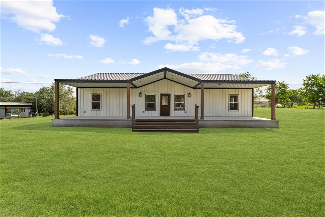 207 South Charles Street George West, TX 78022 - Photo 2 of 24 a front view of a house with a garden