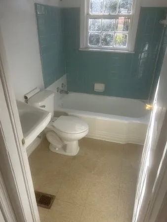 a bathroom with a toilet and a bathtub