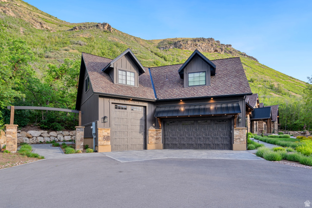 1141 South Oak Leaf Lane Springville, UT 84663 - Photo 5 of 147 Exterior featuring board and batten siding, multiple garage doors, stone accents, and dormer windows