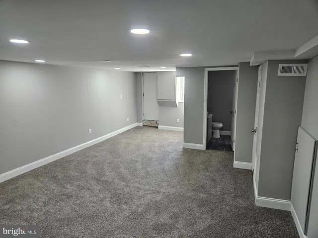 an empty room with a empty space and windows