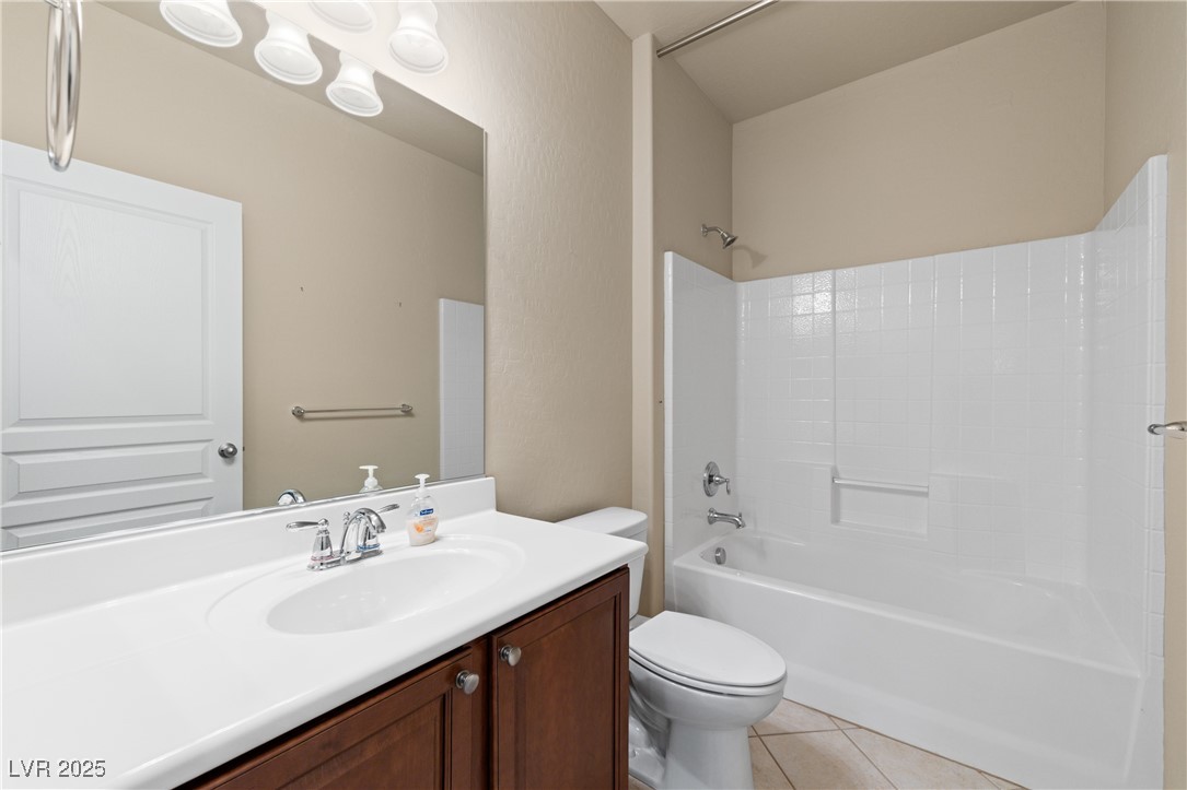 1551 Watchmans Point Mesquite, NV 89034 - Photo 11 of 62 Bathroom featuring washtub / shower combination, light tile patterned floors, and vanity