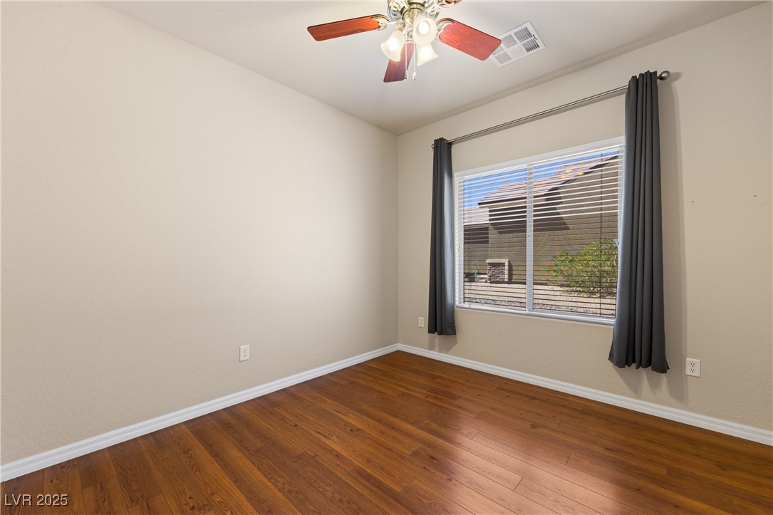1551 Watchmans Point Mesquite, NV 89034 - Photo 15 of 62 Empty room with dark wood-type flooring and a ceiling fan