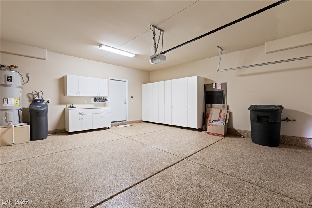1551 Watchmans Point Mesquite, NV 89034 - Photo 16 of 62 Garage featuring water heater and a garage door opener
