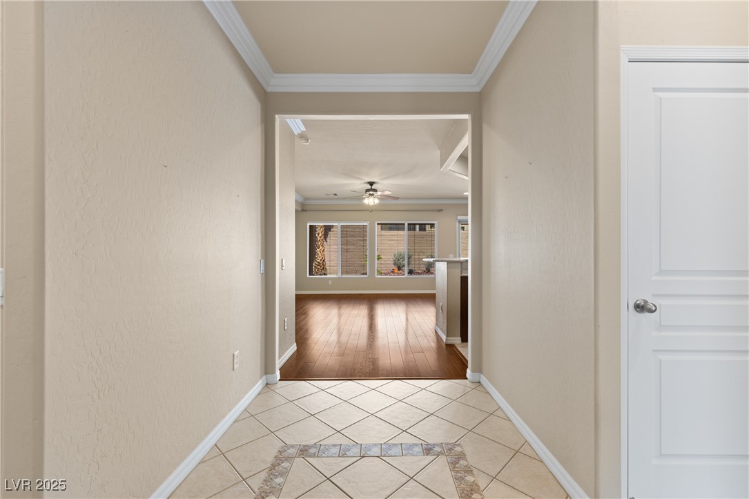 1551 Watchmans Point Mesquite, NV 89034 - Photo 17 of 62 Hall with ornamental molding, inlaid floor details, and light tile patterned floors