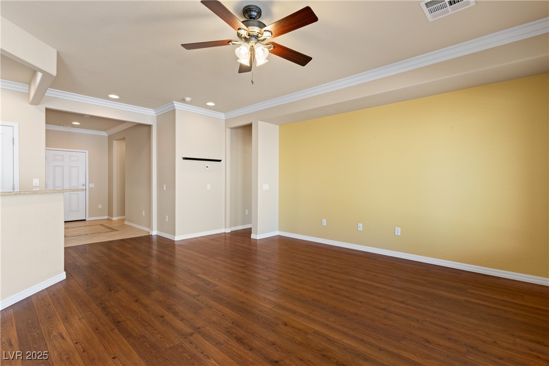 1551 Watchmans Point Mesquite, NV 89034 - Photo 20 of 62 Unfurnished living room with ornamental molding, dark wood-type flooring, recessed lighting, and ceiling fan