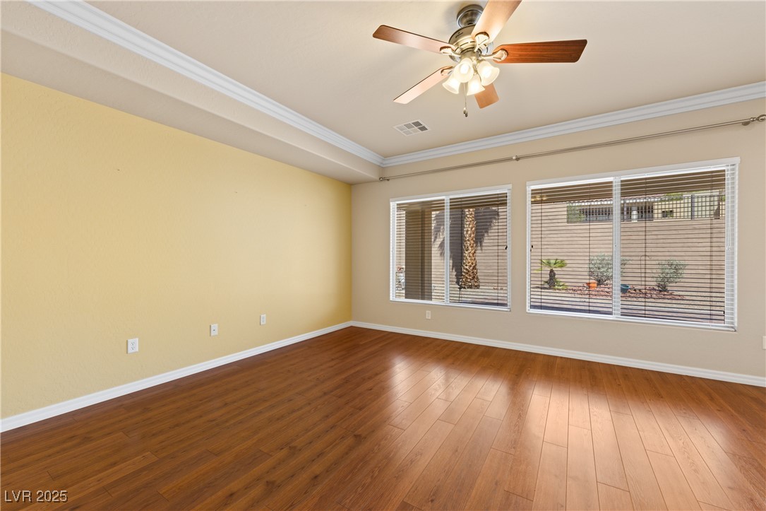 1551 Watchmans Point Mesquite, NV 89034 - Photo 21 of 62 Empty room featuring crown molding, wood finished floors, and a ceiling fan