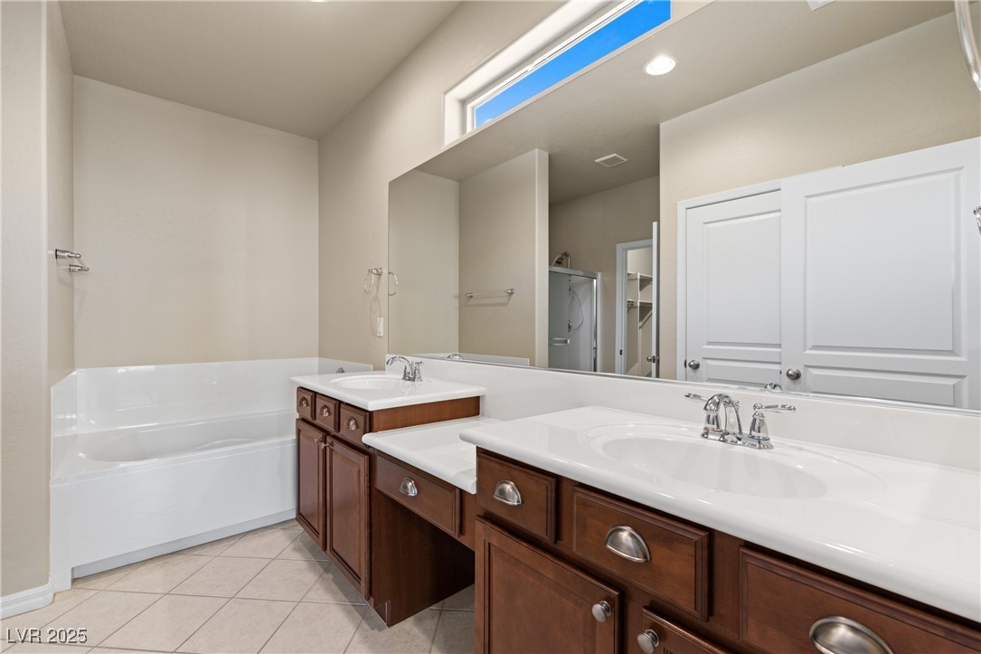 1551 Watchmans Point Mesquite, NV 89034 - Photo 31 of 62 Full bathroom with light tile patterned flooring, a shower stall, double vanity, and a garden tub