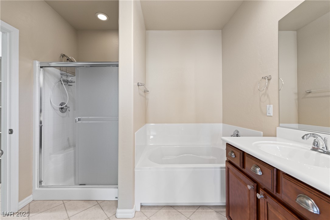 1551 Watchmans Point Mesquite, NV 89034 - Photo 32 of 62 Bathroom with light tile patterned flooring, a stall shower, and vanity