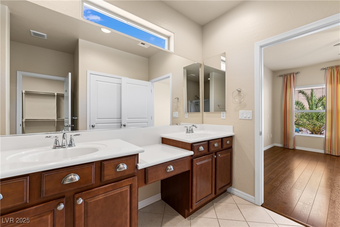 1551 Watchmans Point Mesquite, NV 89034 - Photo 34 of 62 Bathroom featuring double vanity, light tile patterned flooring, and a walk in closet