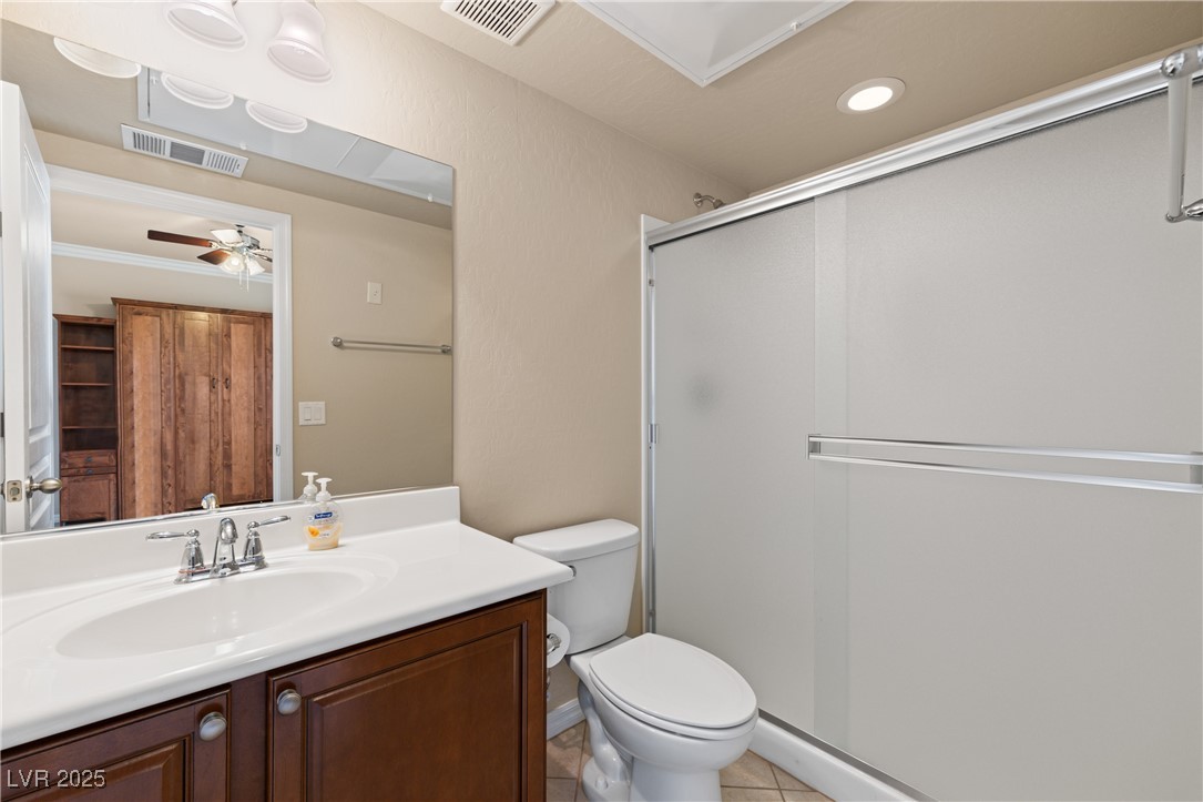 1551 Watchmans Point Mesquite, NV 89034 - Photo 38 of 62 Full bath with a shower stall, vanity, light tile patterned flooring, ceiling fan, and recessed lighting