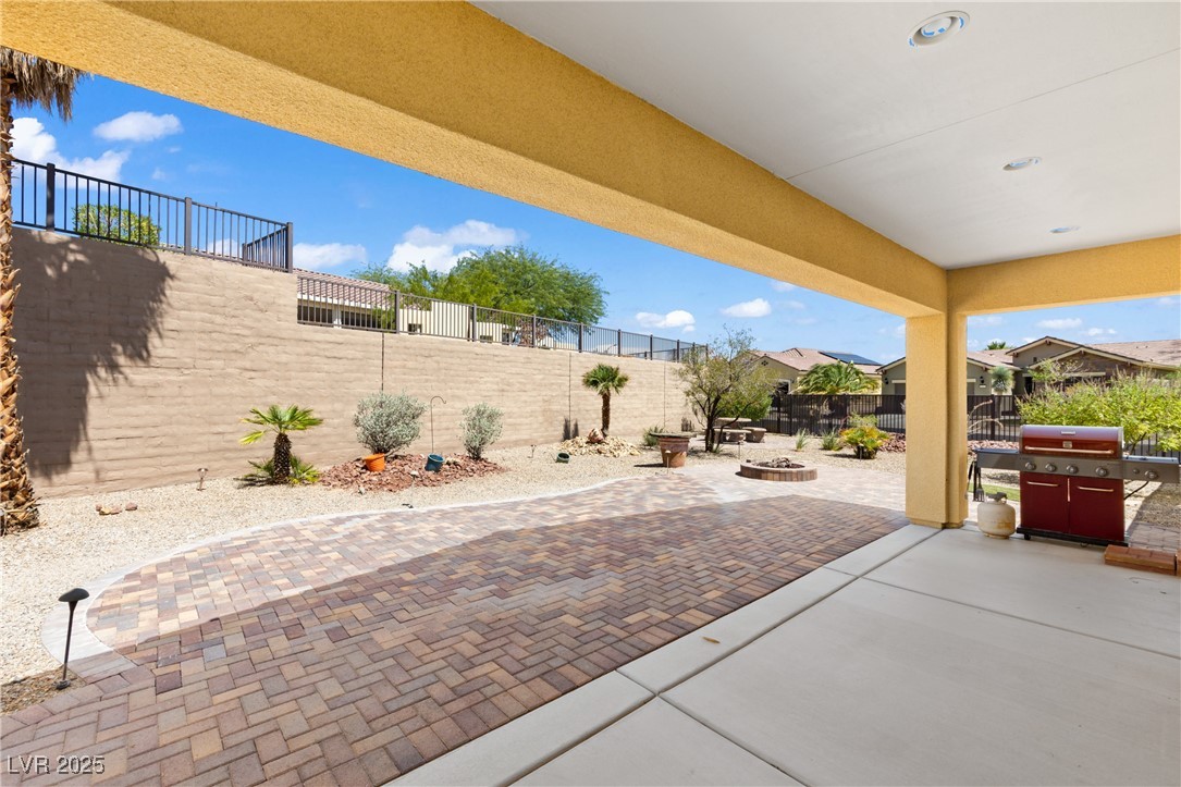 1551 Watchmans Point Mesquite, NV 89034 - Photo 44 of 62 Fenced backyard with a fire pit, a patio area, and area for grilling