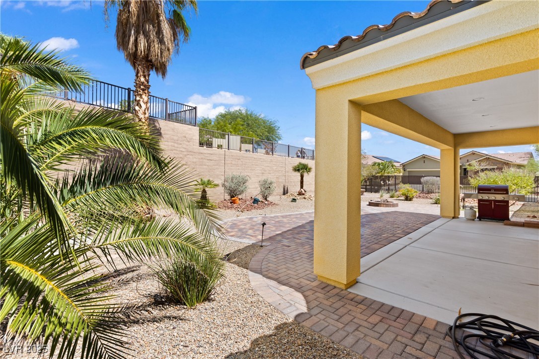 1551 Watchmans Point Mesquite, NV 89034 - Photo 45 of 62 Fenced backyard featuring a patio, area for grilling, and a fire pit
