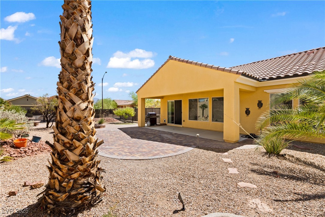 1551 Watchmans Point Mesquite, NV 89034 - Photo 48 of 62 Rear view of house featuring a patio, stucco siding, and a tiled roof
