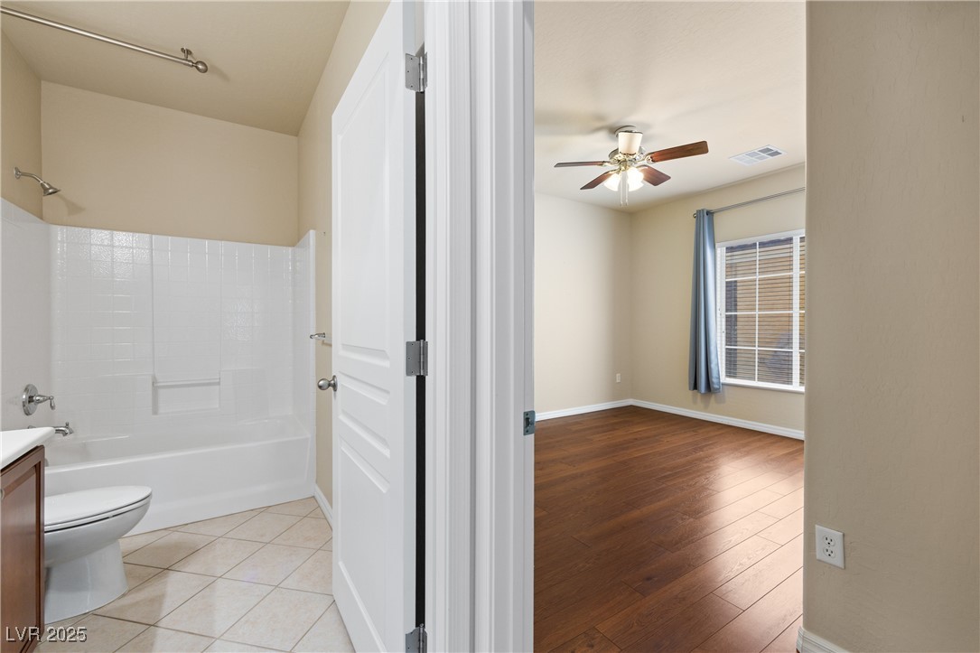 1551 Watchmans Point Mesquite, NV 89034 - Photo 10 of 62 Bathroom featuring shower / bathtub combination, vanity, light wood finished floors, and ceiling fan