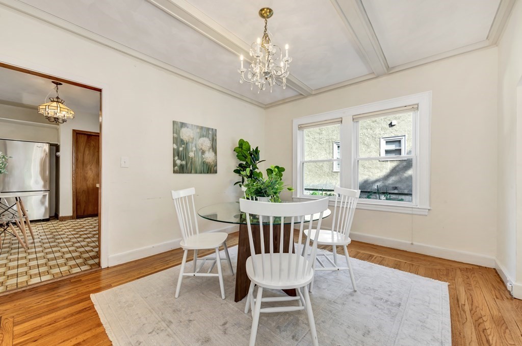 34 Harvard Street, Unit 1 Arlington, MA 02476 - Photo 11 of 36 a view of a dining room with furniture and wooden floor
