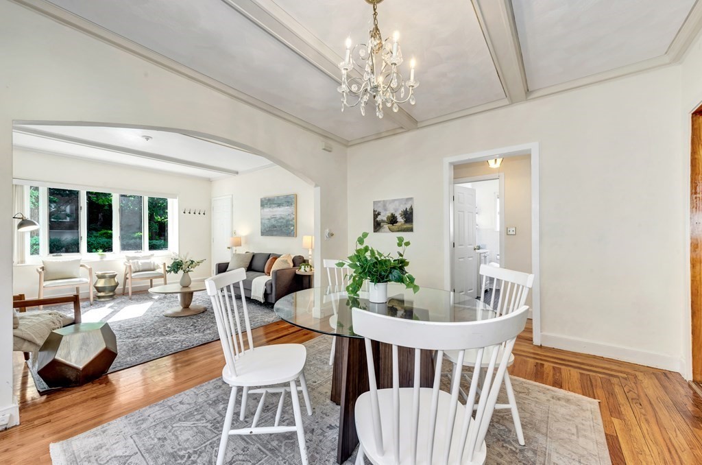 34 Harvard Street, Unit 1 Arlington, MA 02476 - Photo 13 of 36 a living room with furniture and a chandelier