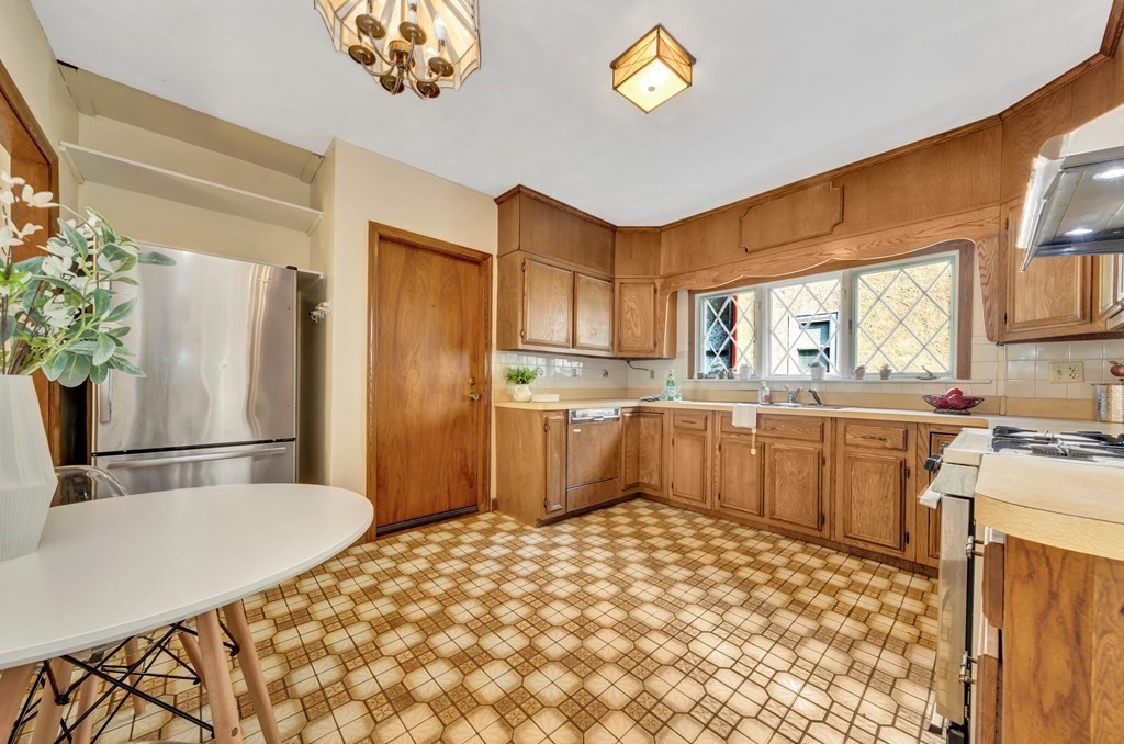 34 Harvard Street, Unit 1 Arlington, MA 02476 - Photo 19 of 36 a kitchen with stainless steel appliances a refrigerator and a stove top oven