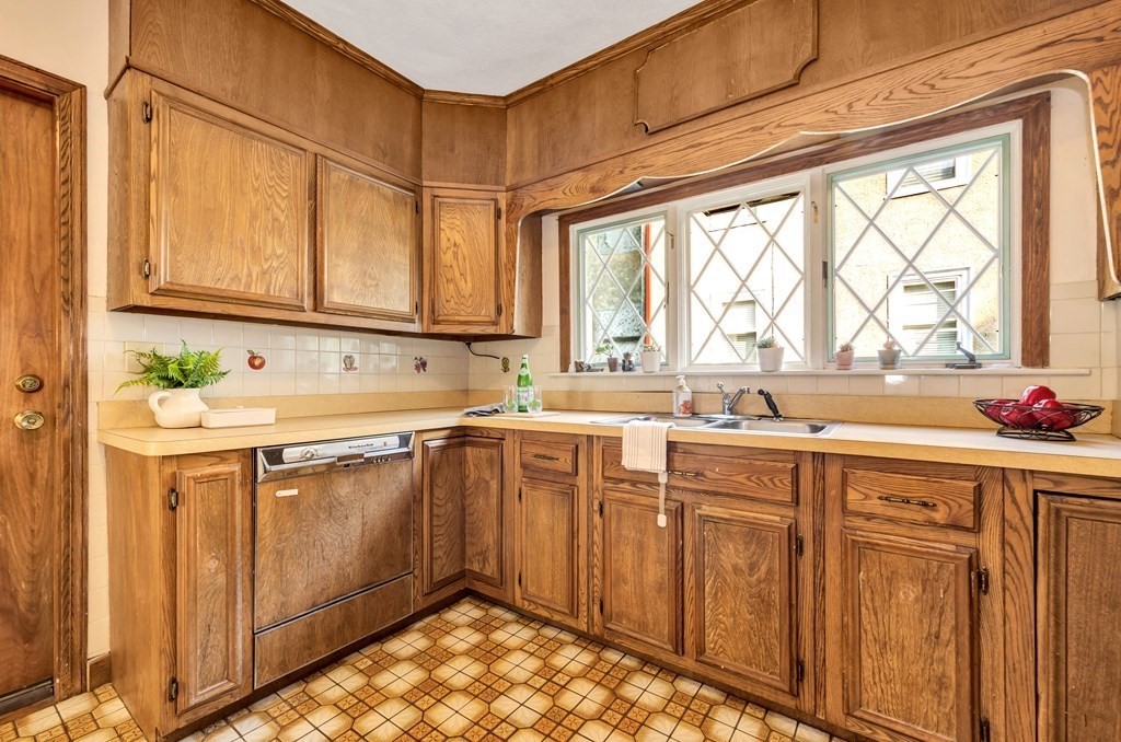 34 Harvard Street, Unit 1 Arlington, MA 02476 - Photo 22 of 36 a kitchen with stainless steel appliances wooden cabinets a sink and a window