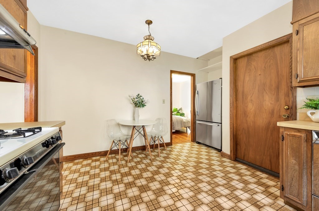 34 Harvard Street, Unit 1 Arlington, MA 02476 - Photo 23 of 36 a view of a dining room with a table and chairs