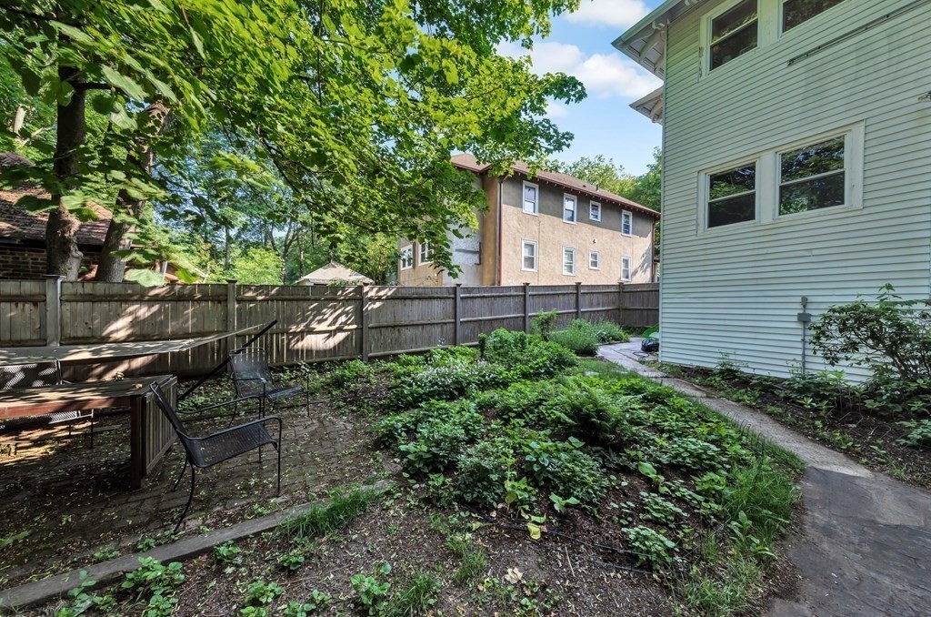 34 Harvard Street, Unit 1 Arlington, MA 02476 - Photo 36 of 36 a backyard of a house with lots of green space