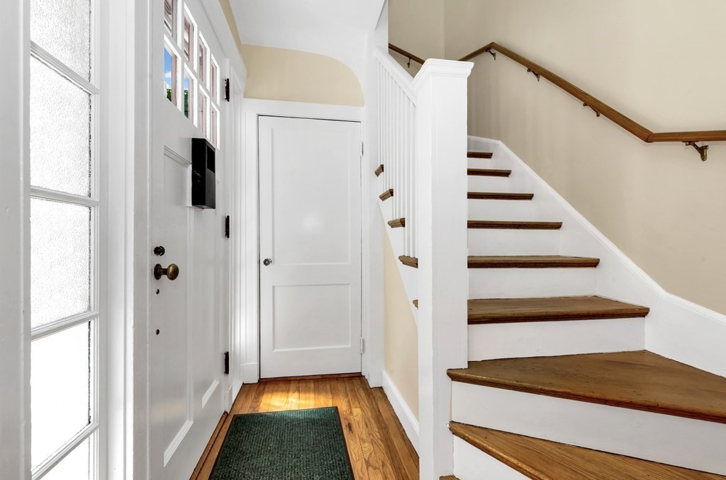 34 Harvard Street, Unit 1 Arlington, MA 02476 - Photo 4 of 36 a view of entryway with wooden floor and stairs