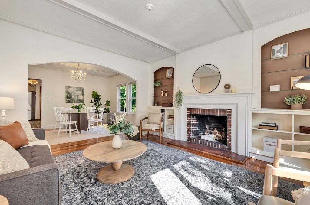 34 Harvard Street, Unit 1 Arlington, MA 02476 - Photo 5 of 36 a living room with furniture a fireplace and a table