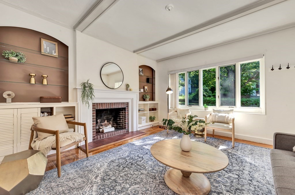 34 Harvard Street, Unit 1 Arlington, MA 02476 - Photo 6 of 36 a living room with furniture a fireplace and a large window