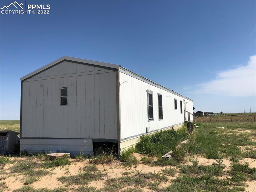 4455 Yoder Road Yoder, CO 80864 - Photo 3 of 12 a front view of a house with a yard