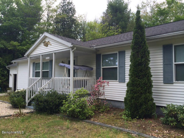 103 Algerie Road Becket, MA 01223 - Photo 1 of 37 a front view of a house with garden