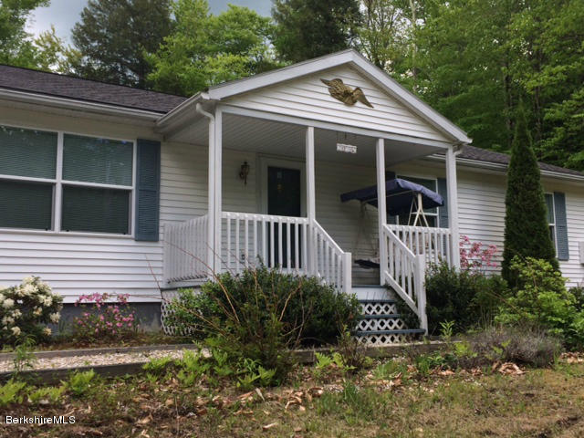 103 Algerie Road Becket, MA 01223 - Photo 3 of 37 a front view of a house with garden