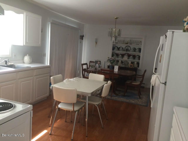 103 Algerie Road Becket, MA 01223 - Photo 23 of 37 a dining room with a table chairs and a refrigerator