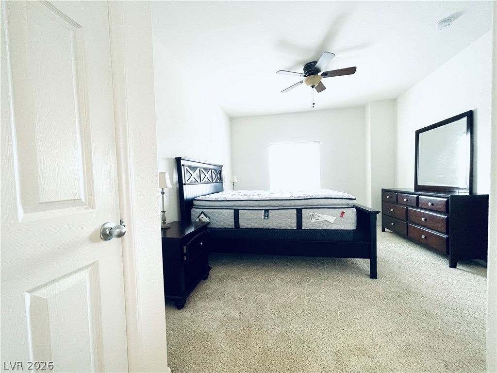 7701 West Robindale Road, Unit 206 Las Vegas, NV 89113 - Photo 13 of 30 Wall-to-wall carpeting and neutral-colored walls anchor this comfortable, light-filled sleeping space.