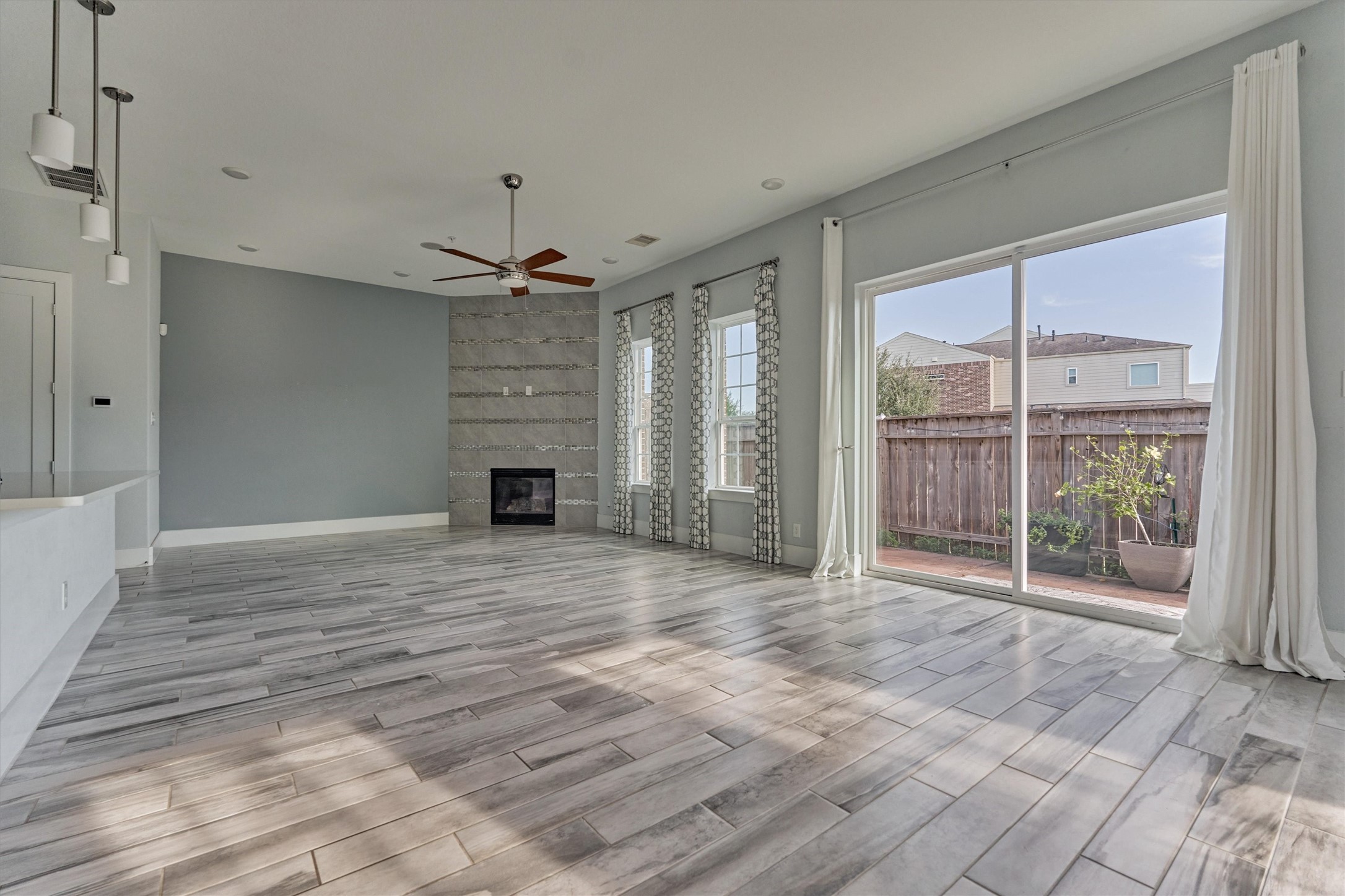 2113 Solstice Boulevard Spring, TX 77386 - Photo 15 of 48 a view of a livingroom with a chandelier a ceiling fan and windows