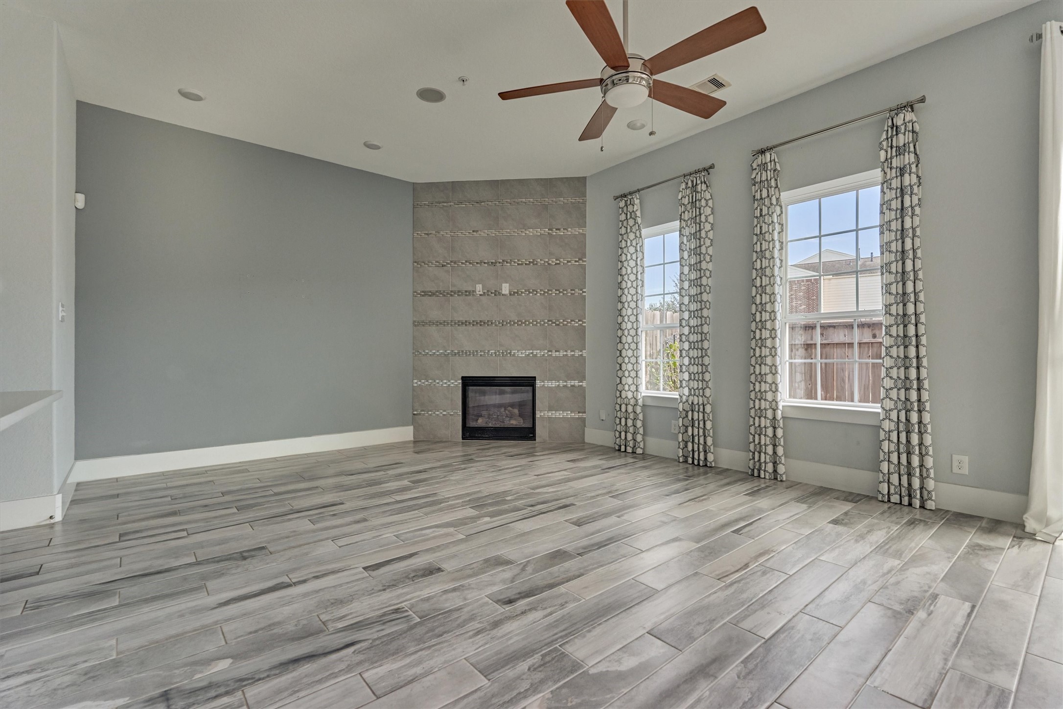 2113 Solstice Boulevard Spring, TX 77386 - Photo 16 of 48 wooden floor fireplace and windows in an empty room