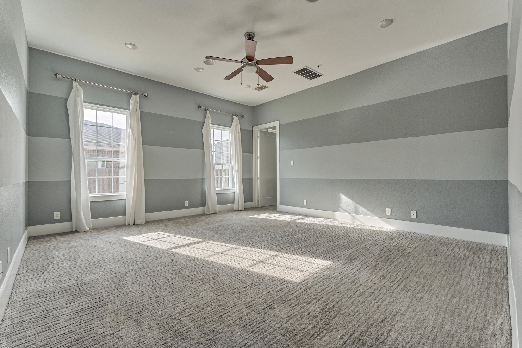 2113 Solstice Boulevard Spring, TX 77386 - Photo 24 of 48 a view of a livingroom with a ceiling fan window and wooden floor