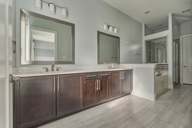 a bathroom with a double vanity sink mirror and