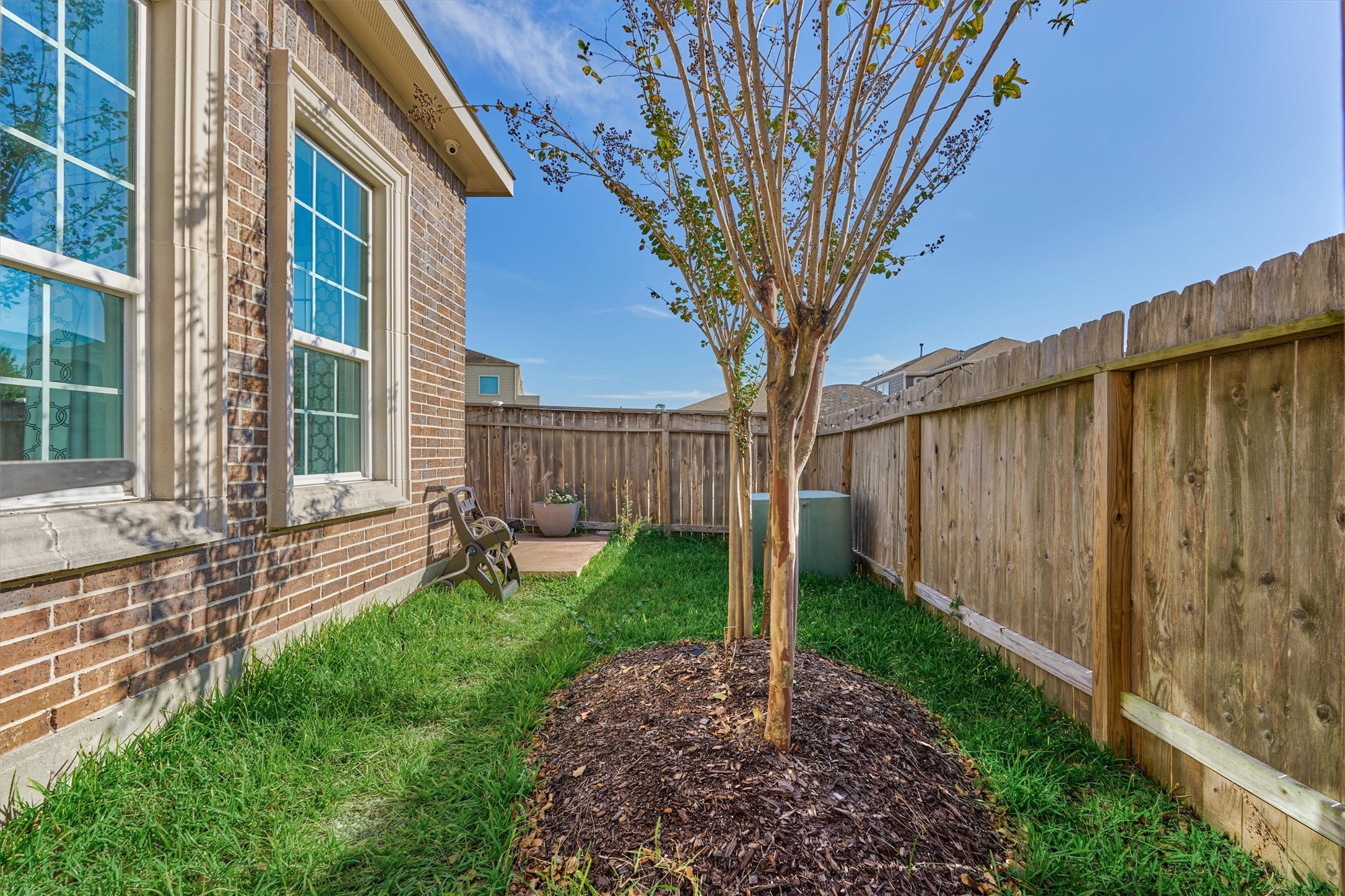 2113 Solstice Boulevard Spring, TX 77386 - Photo 45 of 48 a tree in front of a house with wooden fence